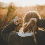 Donna con capelli fini raccolti con doppio legaccio, resistenti al vento estivo, senza nodi.